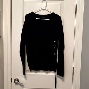 Navy sweater with tie on the left side.